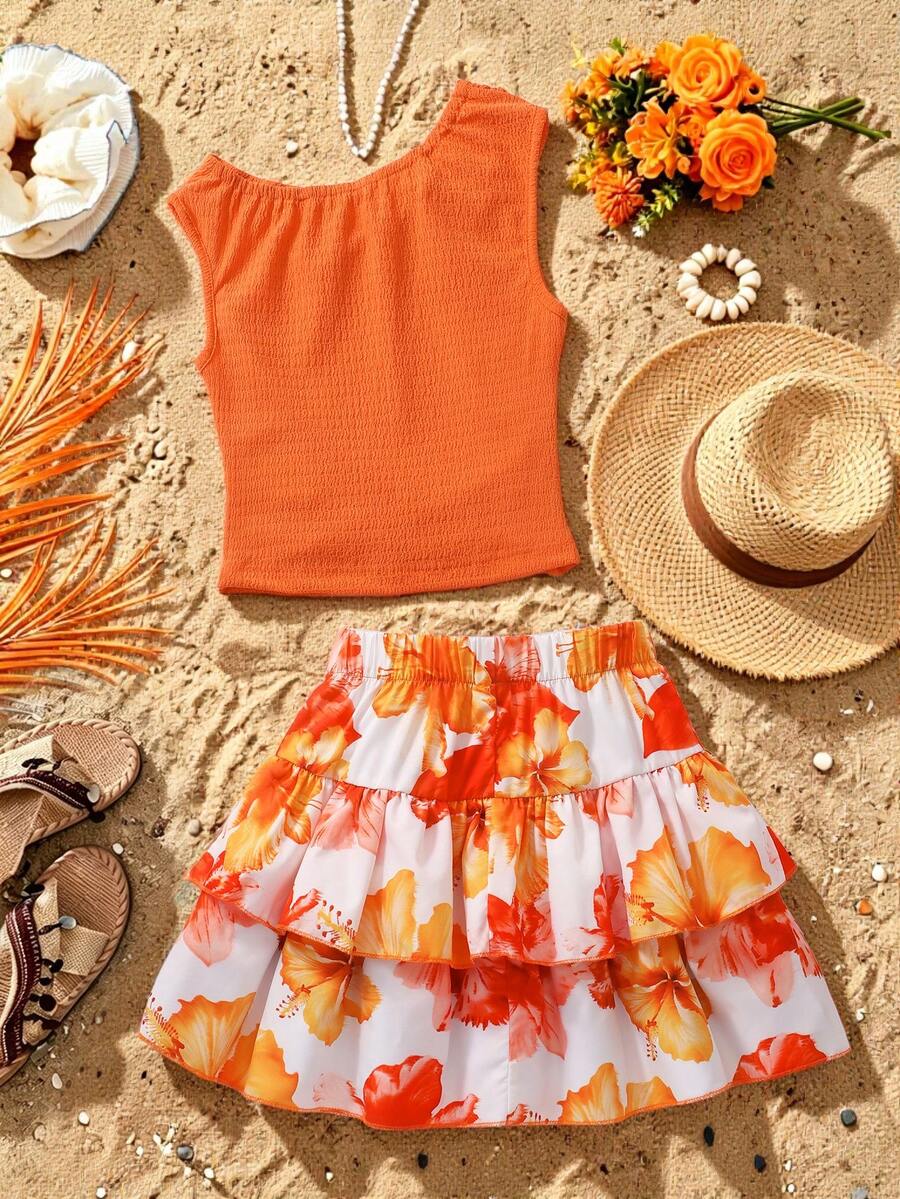 Light blue two-piece outfit set for tween girls with a sleeveless round neck vest top and a tiered ruffle cake skirt featuring a plant pattern.