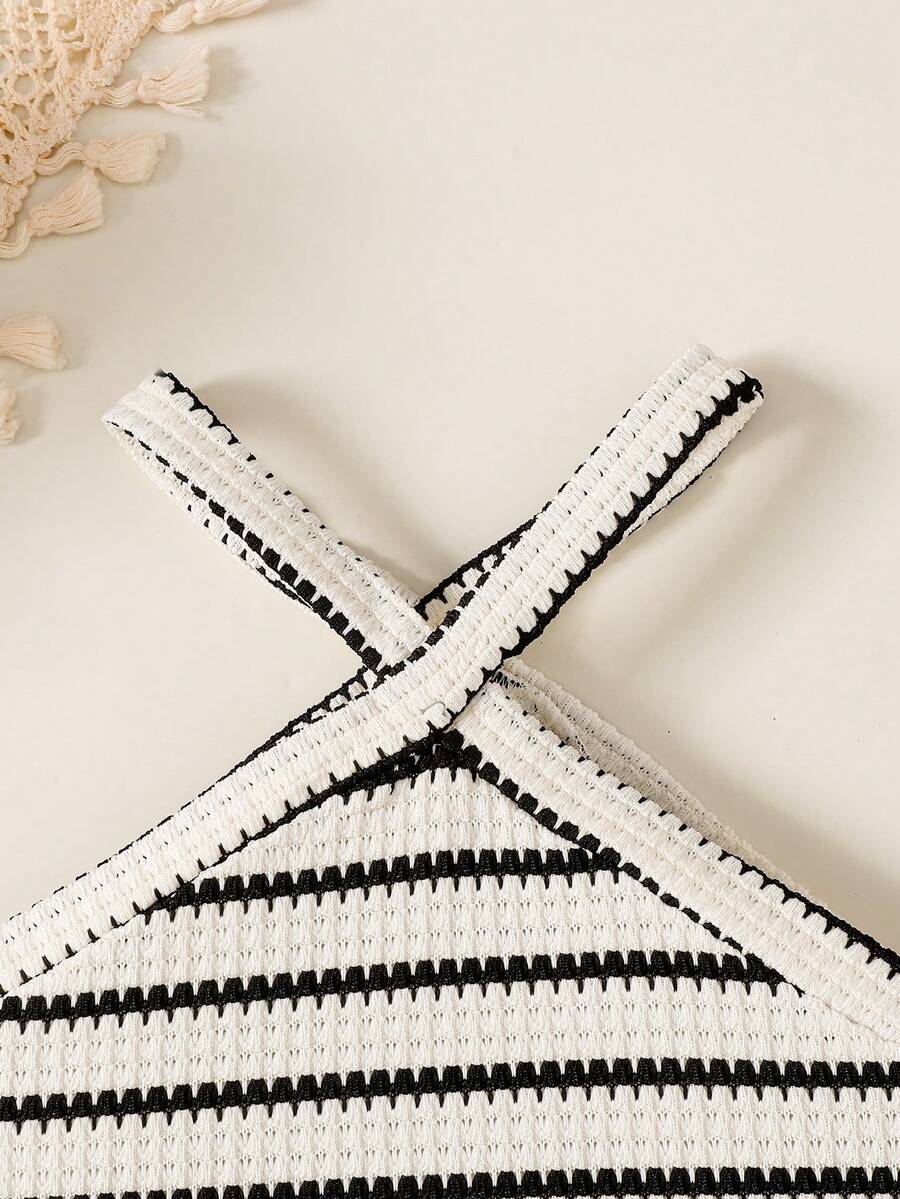Black and white striped 2-piece set for tween girls featuring a halter sleeveless pullover top with criss-cross knot detail and matching paperbag waist shorts.
