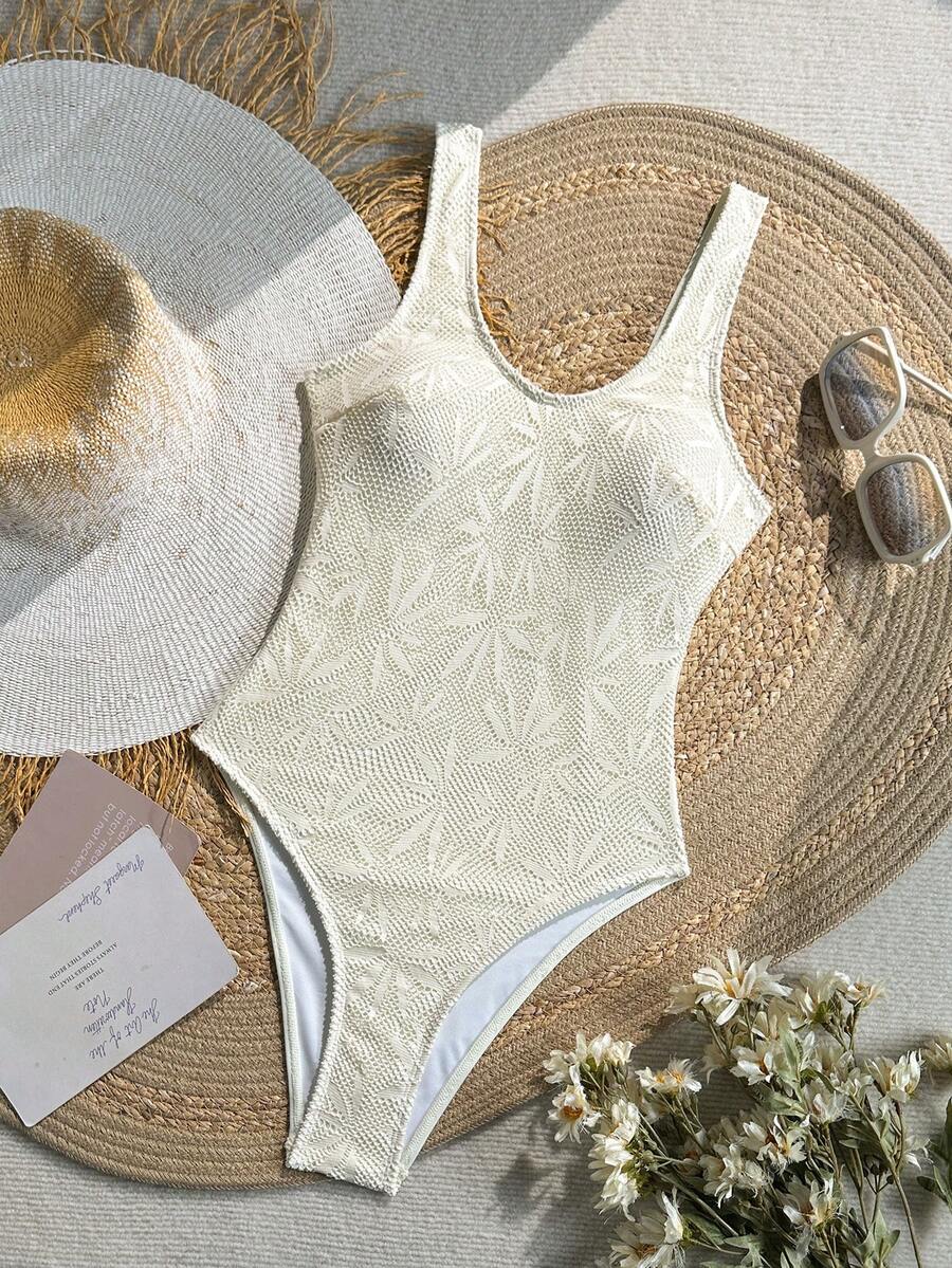 Women's solid color one-piece swimsuit featuring a backless scoop neck design and high cut fit