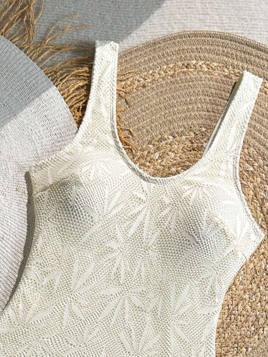 Women's solid color one-piece swimsuit featuring a backless scoop neck design and high cut fit