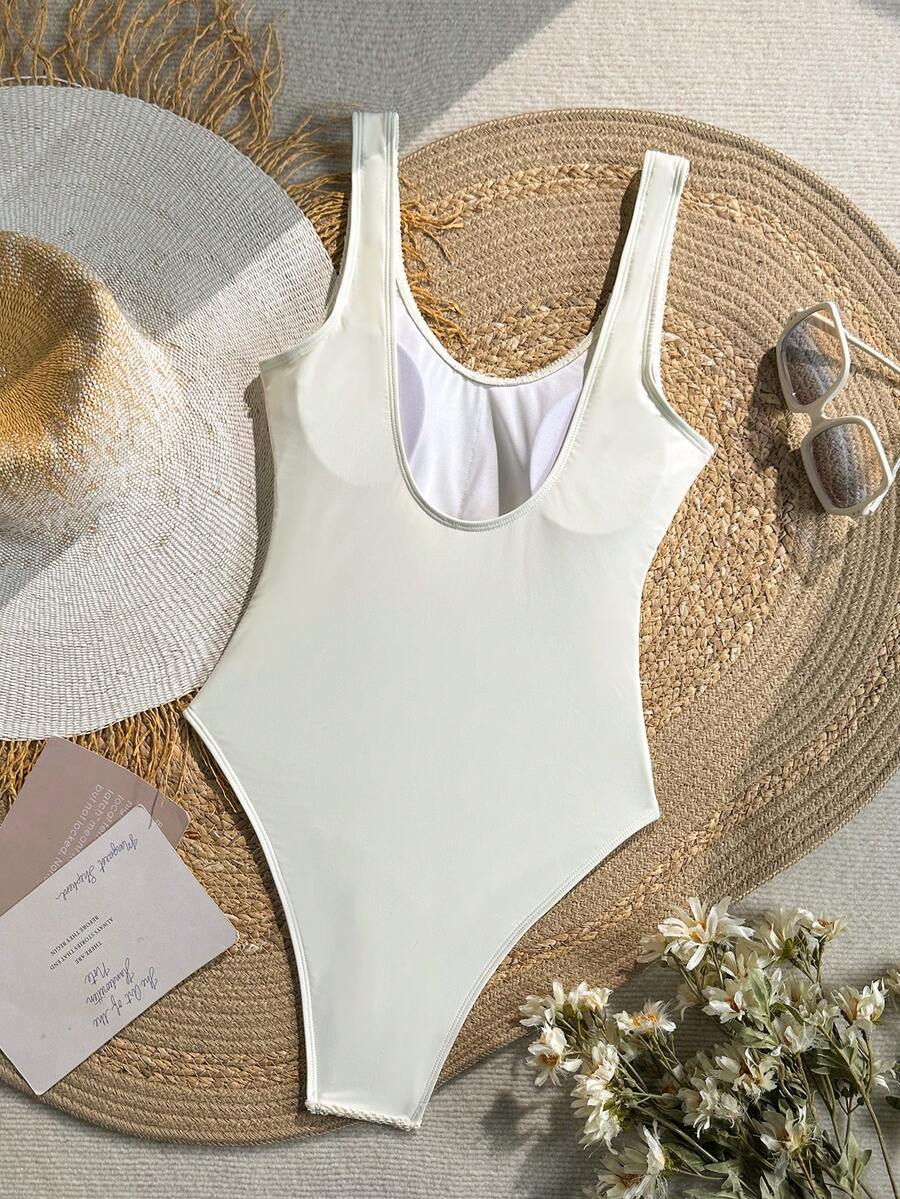 Women's solid color one-piece swimsuit featuring a backless scoop neck design and high cut fit