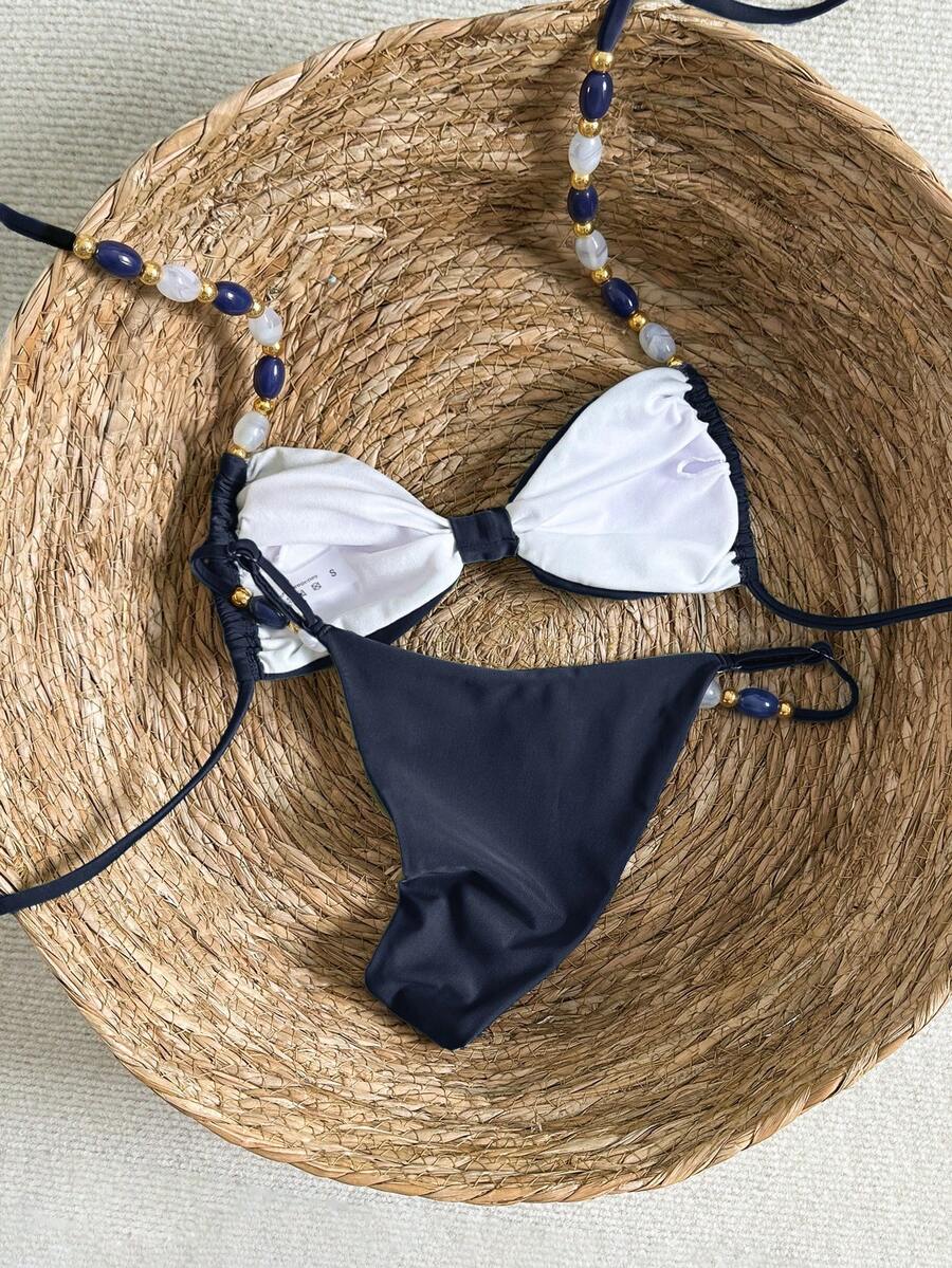 Women's green halter neck bikini set featuring color-block beaded shoulder straps, back tie detail, and high cut bottoms.