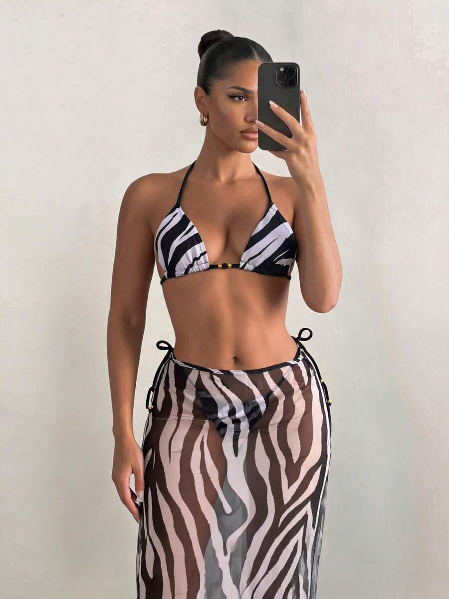 Women's 3-piece zebra print swimwear set featuring a wireless halter top, tie-side bottoms, and a long sheer mesh skirt cover-up.