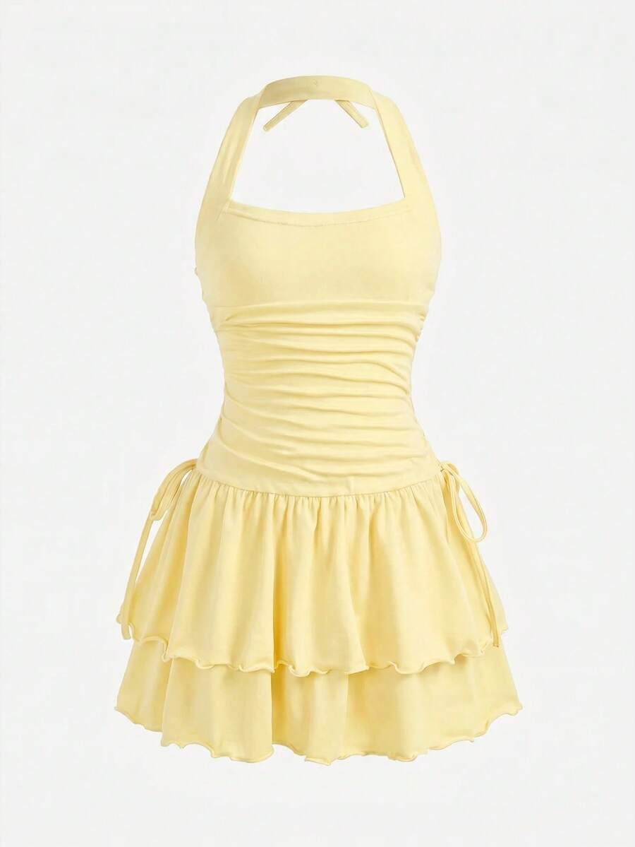 Black sleeveless halter polka dot mini dress for tween girls featuring a high waist and flared hem
