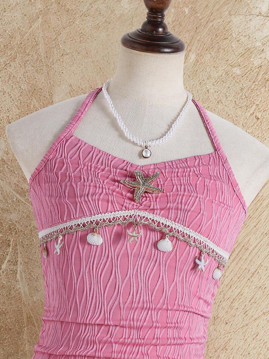 Tween girls apricot sleeveless halter mini dress with textured starfish and shell decor, shirred tiered layer, high waist, and flounce hem.