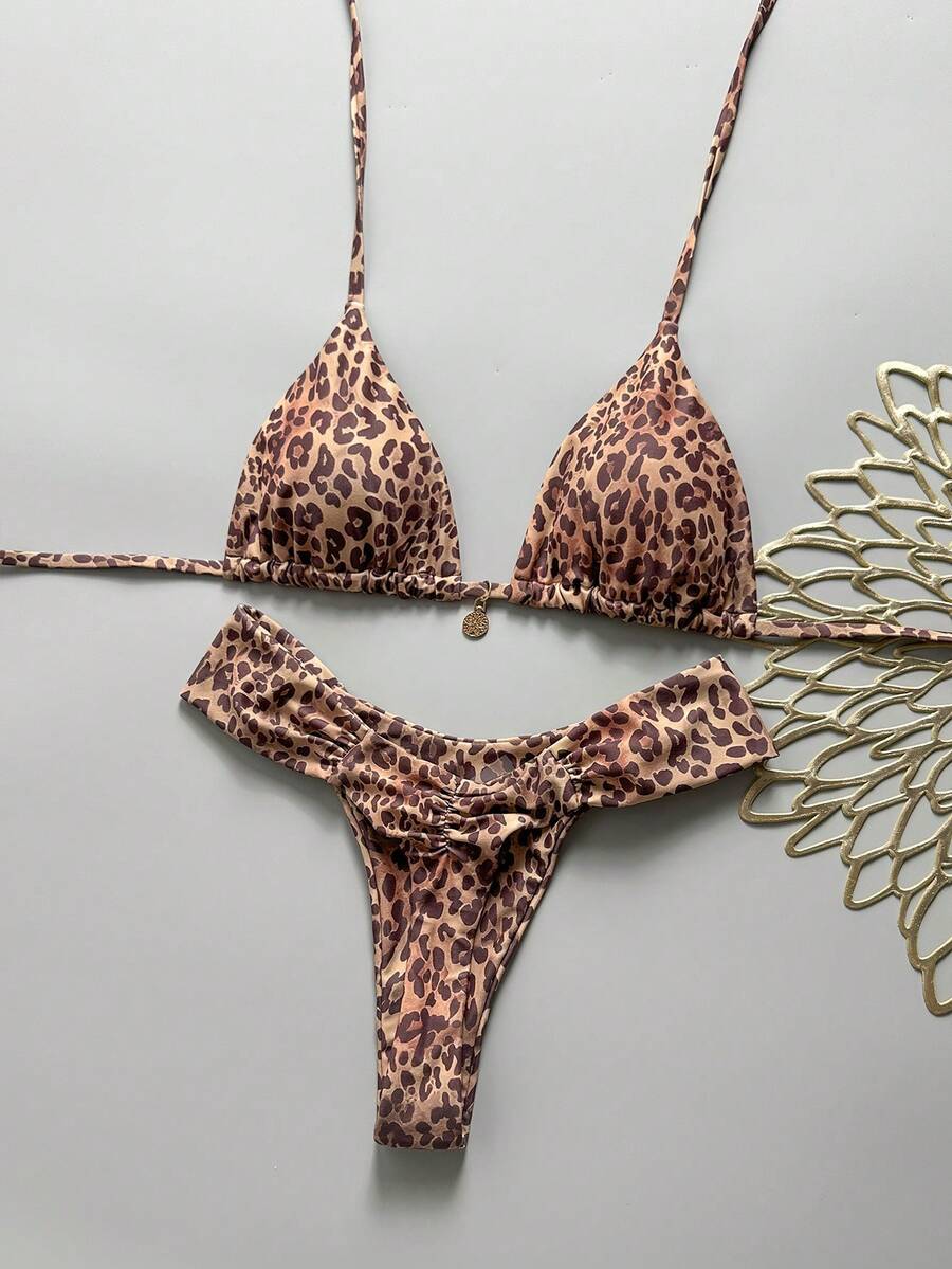 Women's 2-piece triangle cup bikini set in solid color featuring woven pearl shell decoration, halter neckline, and high-waist side-tie ruched bottoms.