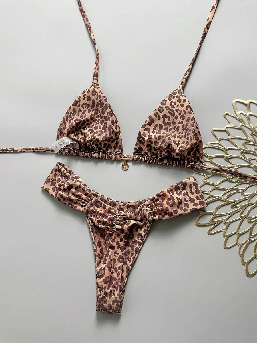 Women's 2-piece triangle cup bikini set in solid color featuring woven pearl shell decoration, halter neckline, and high-waist side-tie ruched bottoms.