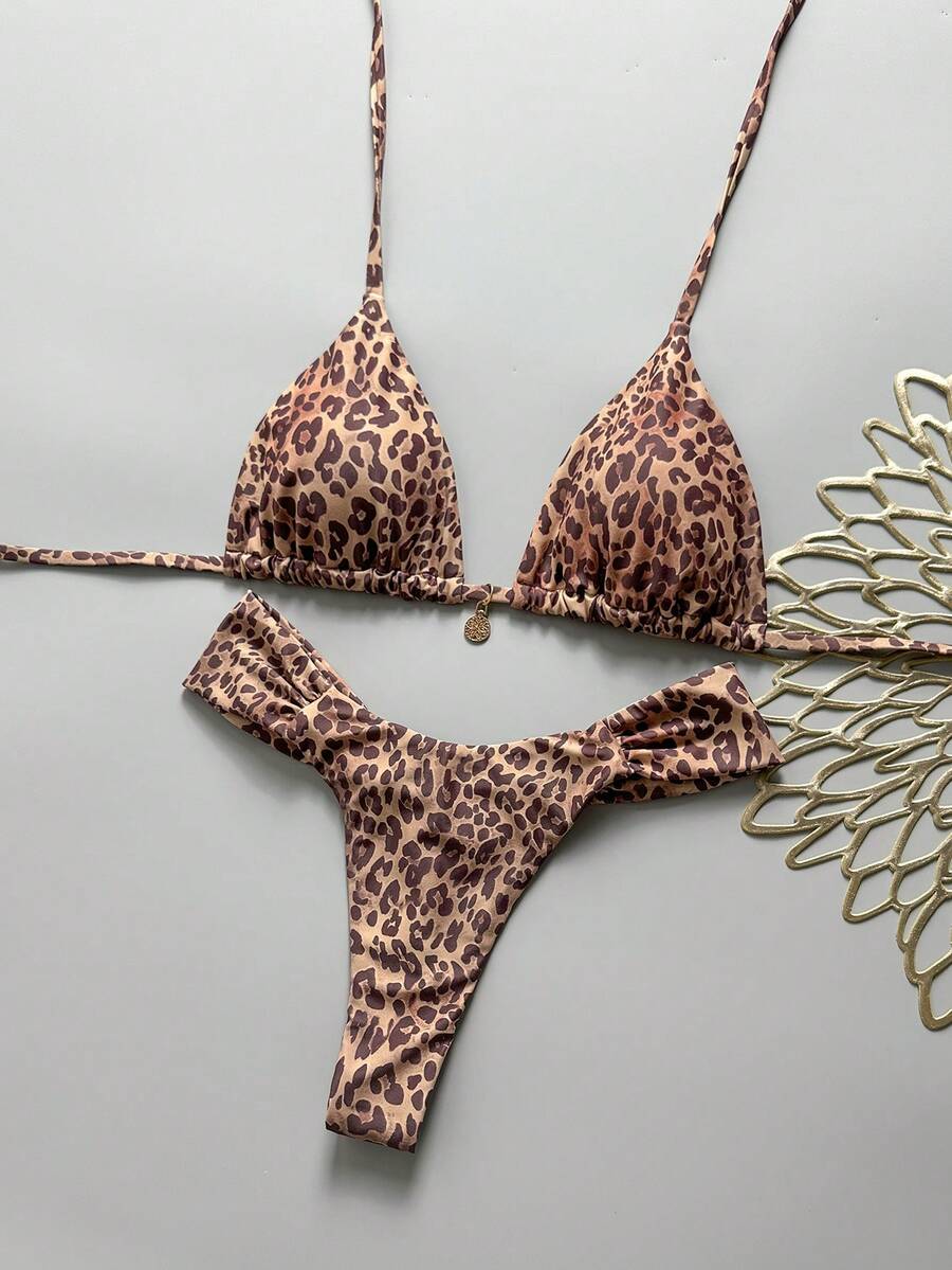 Women's 2-piece triangle cup bikini set in solid color featuring woven pearl shell decoration, halter neckline, and high-waist side-tie ruched bottoms.