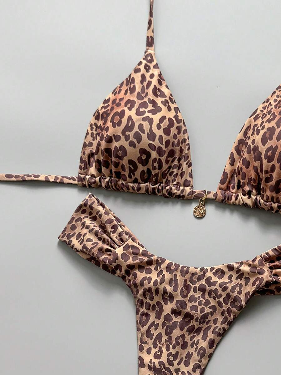 Women's 2-piece triangle cup bikini set in solid color featuring woven pearl shell decoration, halter neckline, and high-waist side-tie ruched bottoms.