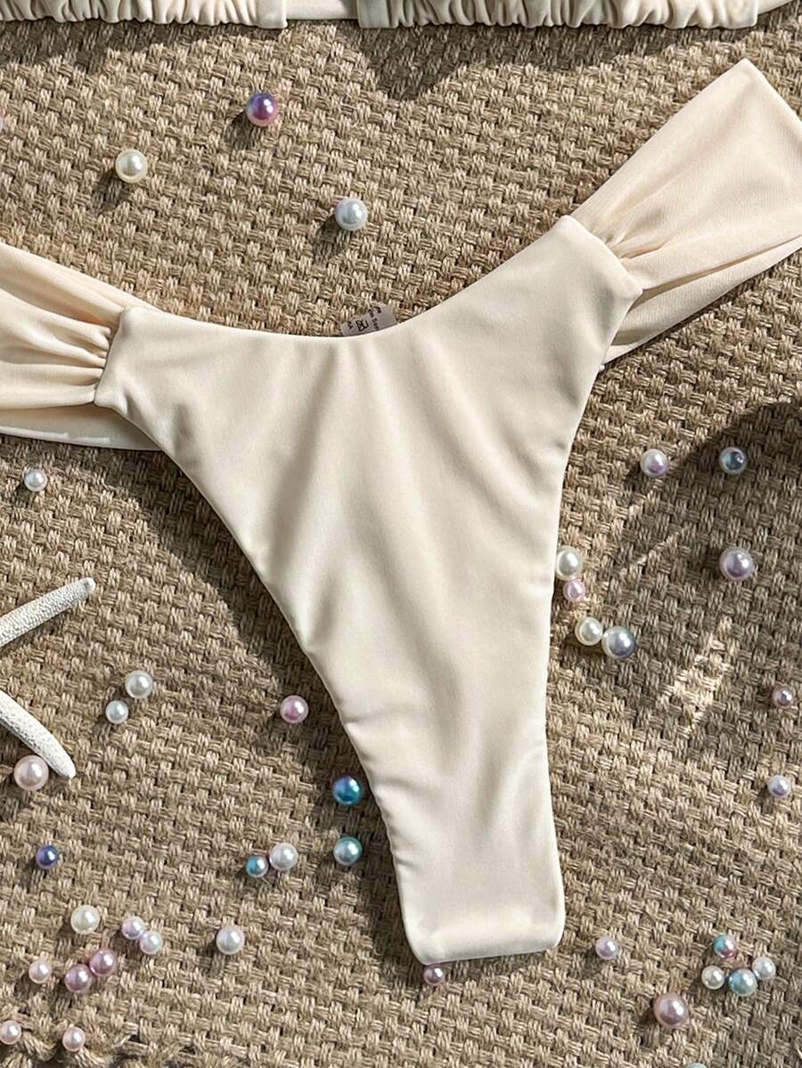 Women's 2-piece triangle cup bikini set in solid color featuring woven pearl shell decoration, halter neckline, and high-waist side-tie ruched bottoms.