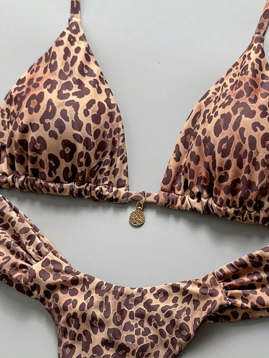 Women's 2-piece triangle cup bikini set in solid color featuring woven pearl shell decoration, halter neckline, and high-waist side-tie ruched bottoms.