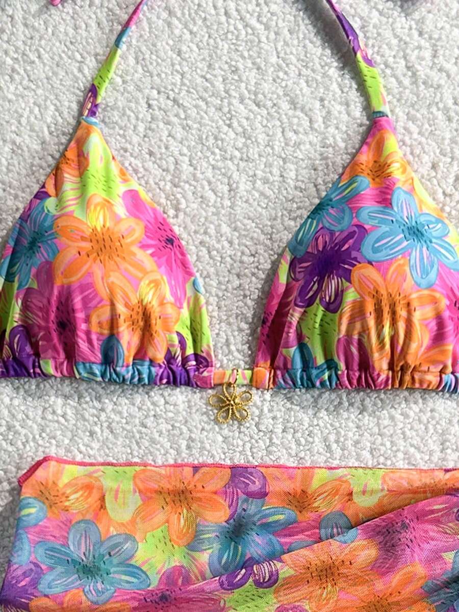Women's 3-piece blue tropical shell print bikini set featuring a halter bralette top, low-waist tie-side bottom, and a matching sheer mesh cover-up skirt.