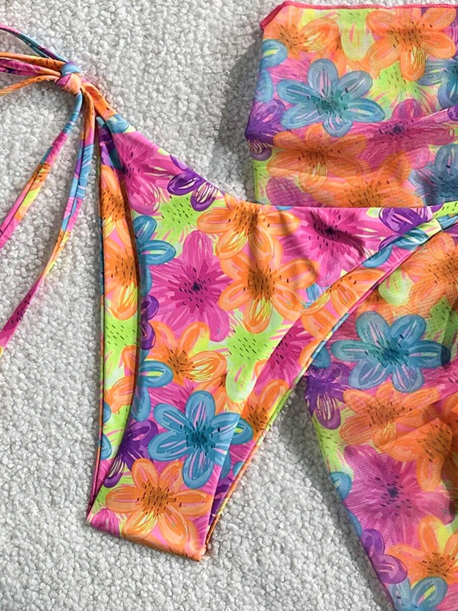 Women's 3-piece blue tropical shell print bikini set featuring a halter bralette top, low-waist tie-side bottom, and a matching sheer mesh cover-up skirt.