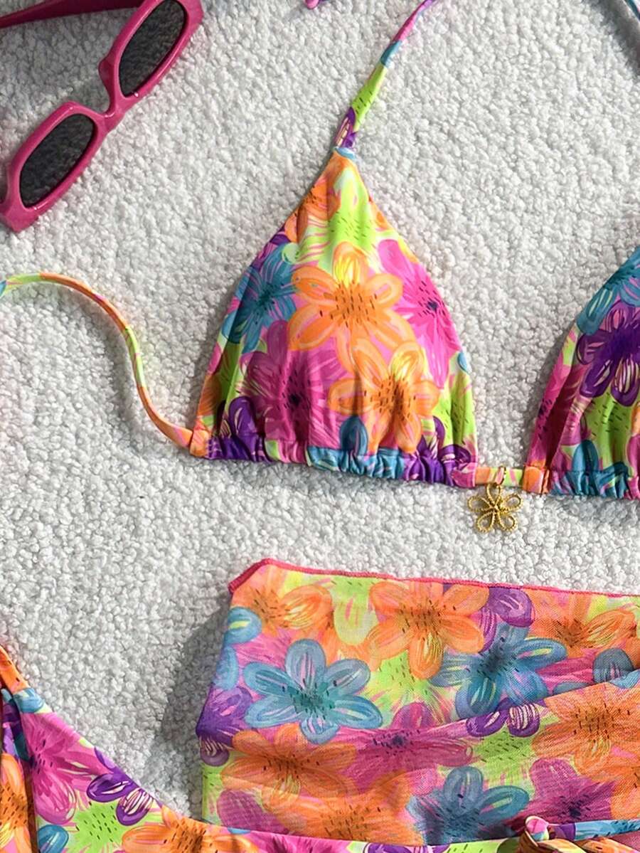Women's 3-piece blue tropical shell print bikini set featuring a halter bralette top, low-waist tie-side bottom, and a matching sheer mesh cover-up skirt.