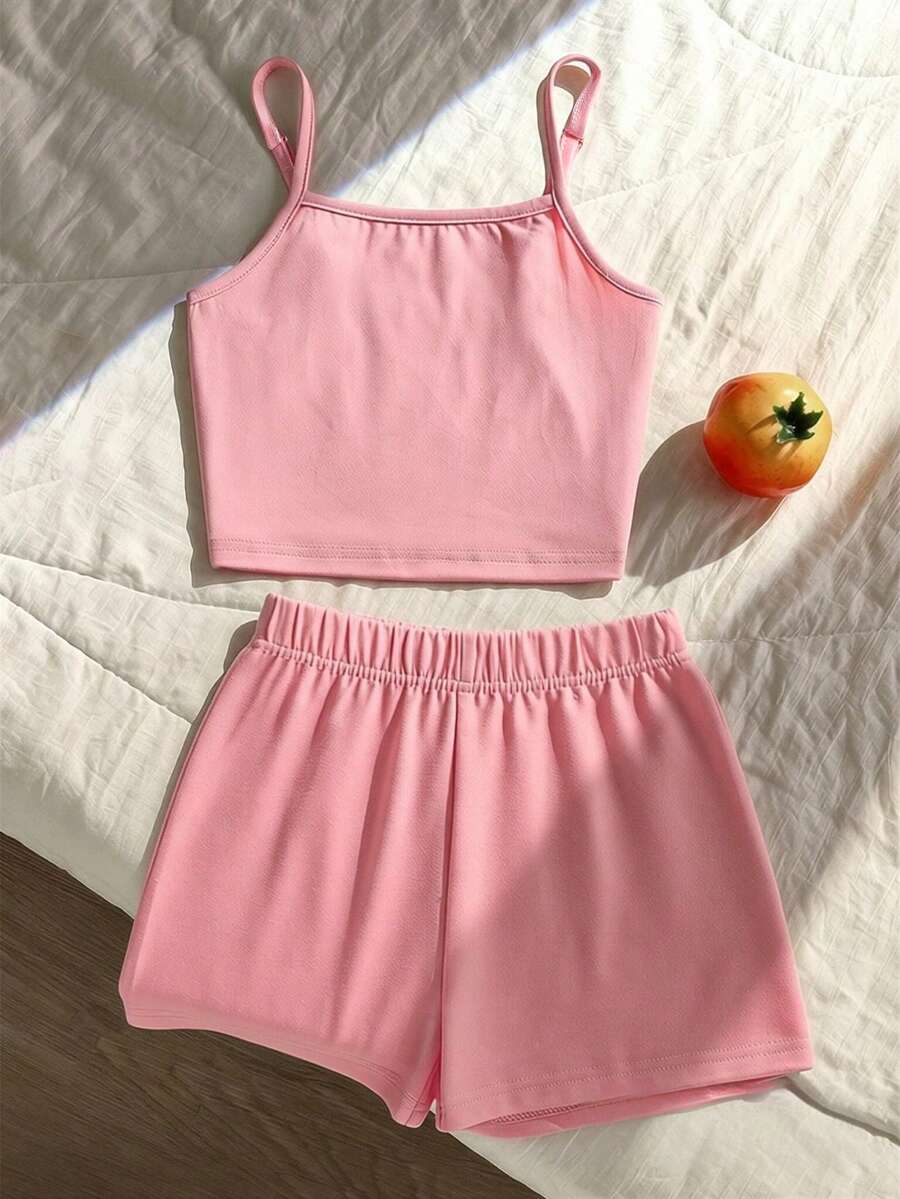 Tween girls summer 2-piece Hawaiian style outfit featuring a graphic print spaghetti strap camisole top with contrast piping and matching casual shorts.