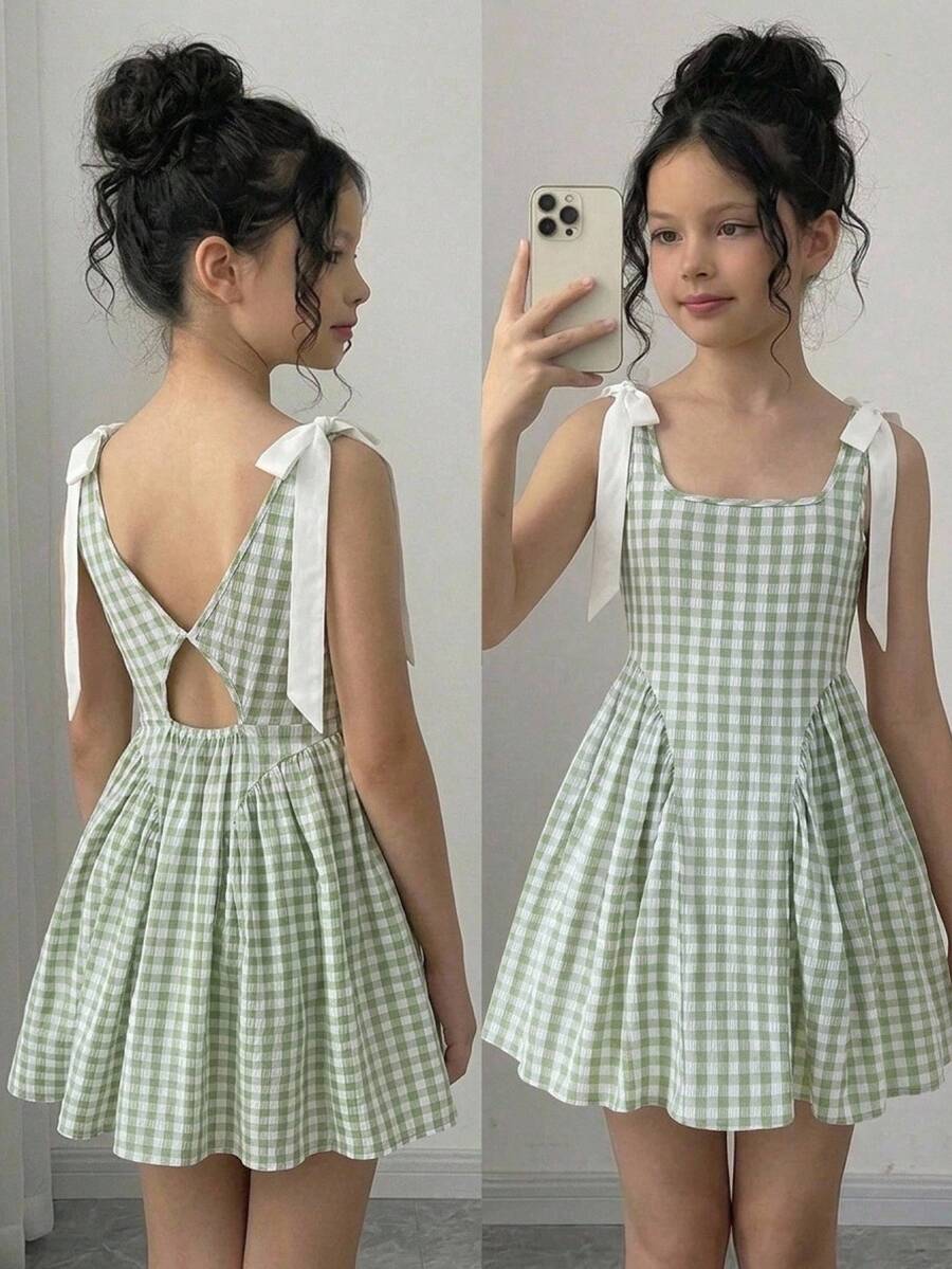 Black and white polka dot sleeveless A-line dress for tween girls featuring a scoop neck, high waist, and flared hem.