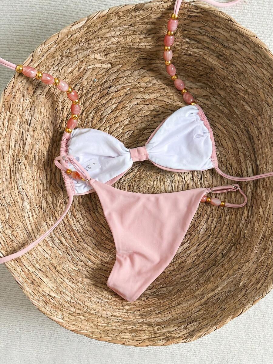 Women's green halter neck bikini set featuring color-block beaded shoulder straps, back tie detail, and high cut bottoms.