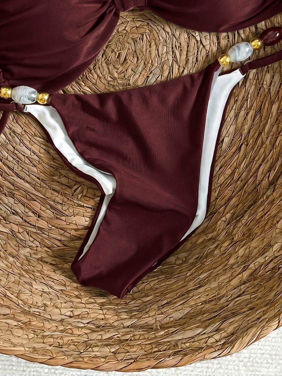 Women's green halter neck bikini set featuring color-block beaded shoulder straps, back tie detail, and high cut bottoms.