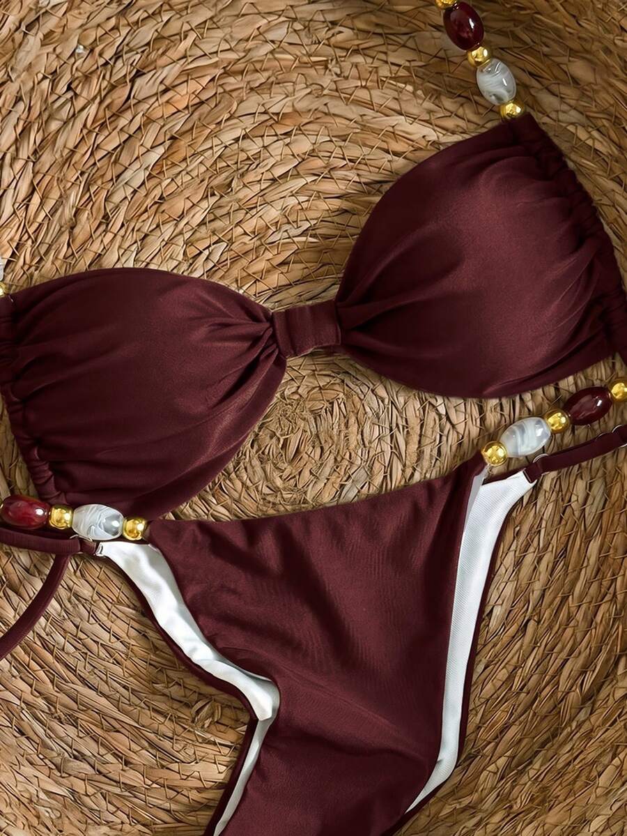 Women's green halter neck bikini set featuring color-block beaded shoulder straps, back tie detail, and high cut bottoms.