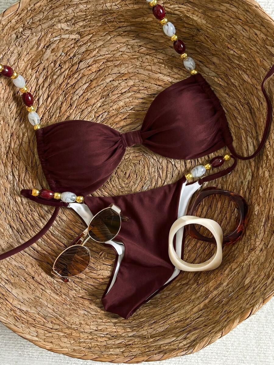 Women's green halter neck bikini set featuring color-block beaded shoulder straps, back tie detail, and high cut bottoms.