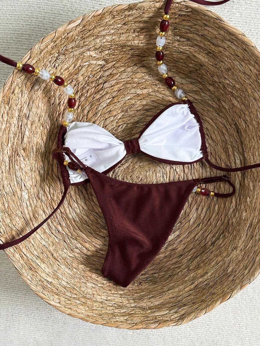 Women's green halter neck bikini set featuring color-block beaded shoulder straps, back tie detail, and high cut bottoms.