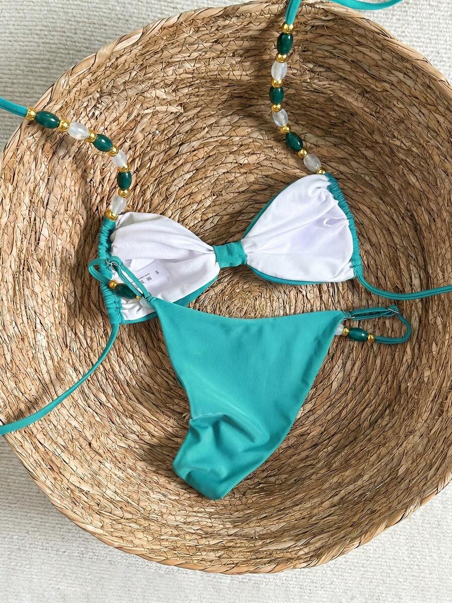 Women's green halter neck bikini set featuring color-block beaded shoulder straps, back tie detail, and high cut bottoms.