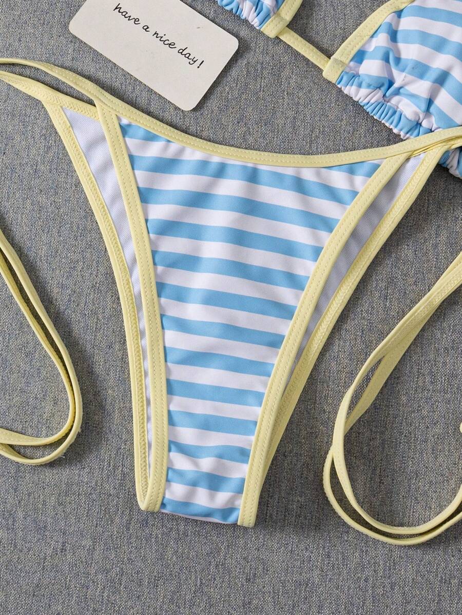 Women's two-piece halter triangle bikini set featuring a backless tie-back top with removable padding and matching tie-side mid-waist bottoms.
