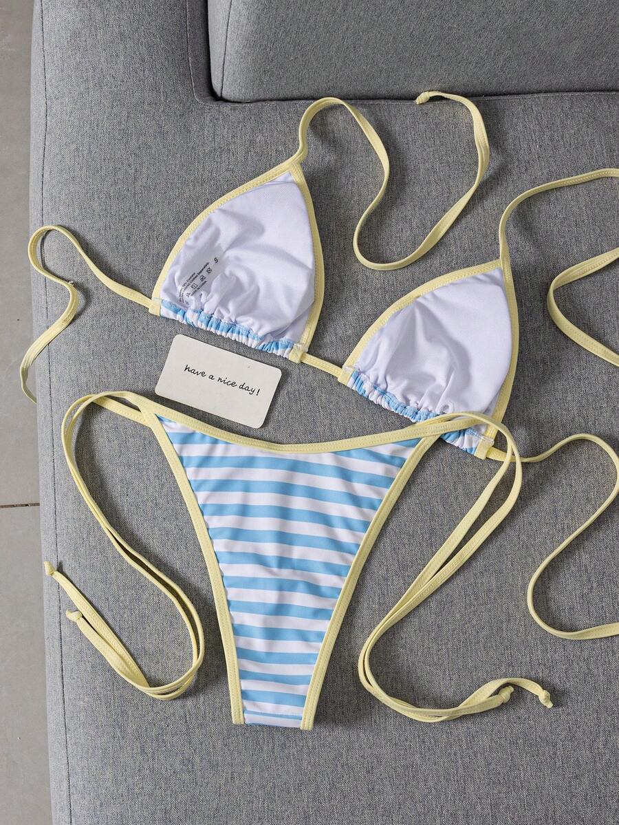 Women's two-piece halter triangle bikini set featuring a backless tie-back top with removable padding and matching tie-side mid-waist bottoms.