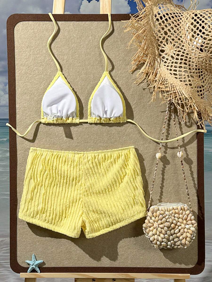 Women's apricot two-piece swimsuit set with a halter tie-back top and matching high stretch shorts.
