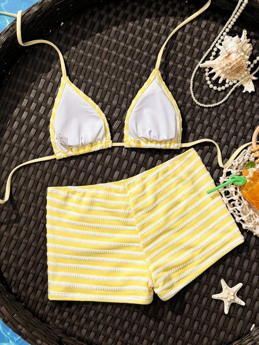 Women's apricot two-piece swimsuit set with a halter tie-back top and matching high stretch shorts.