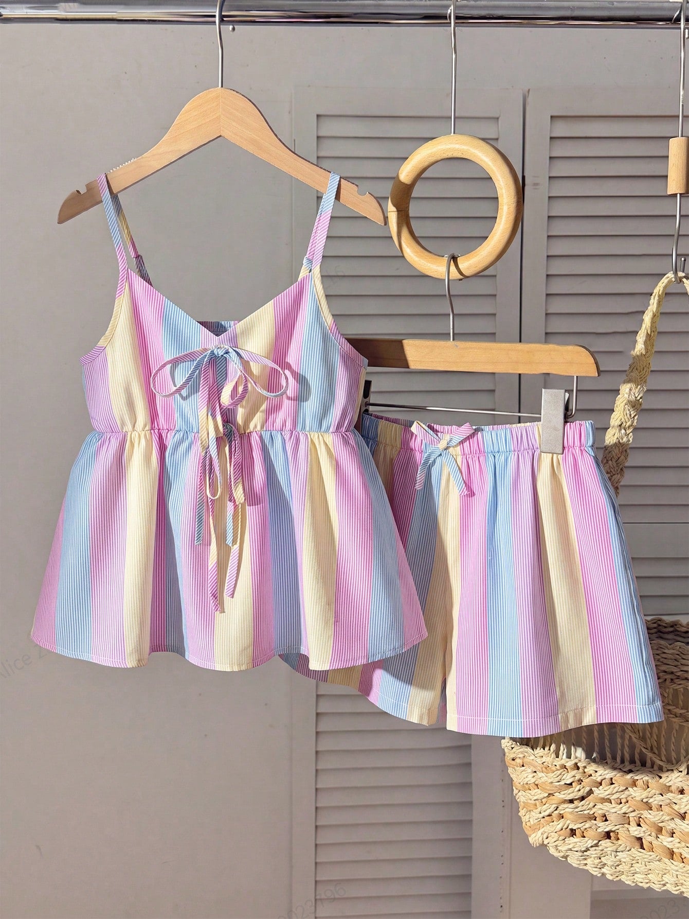Tween girls 2-piece summer vacation set featuring a multicolored geometric print sleeveless camisole top with bow knot detail and matching elastic waist shorts.