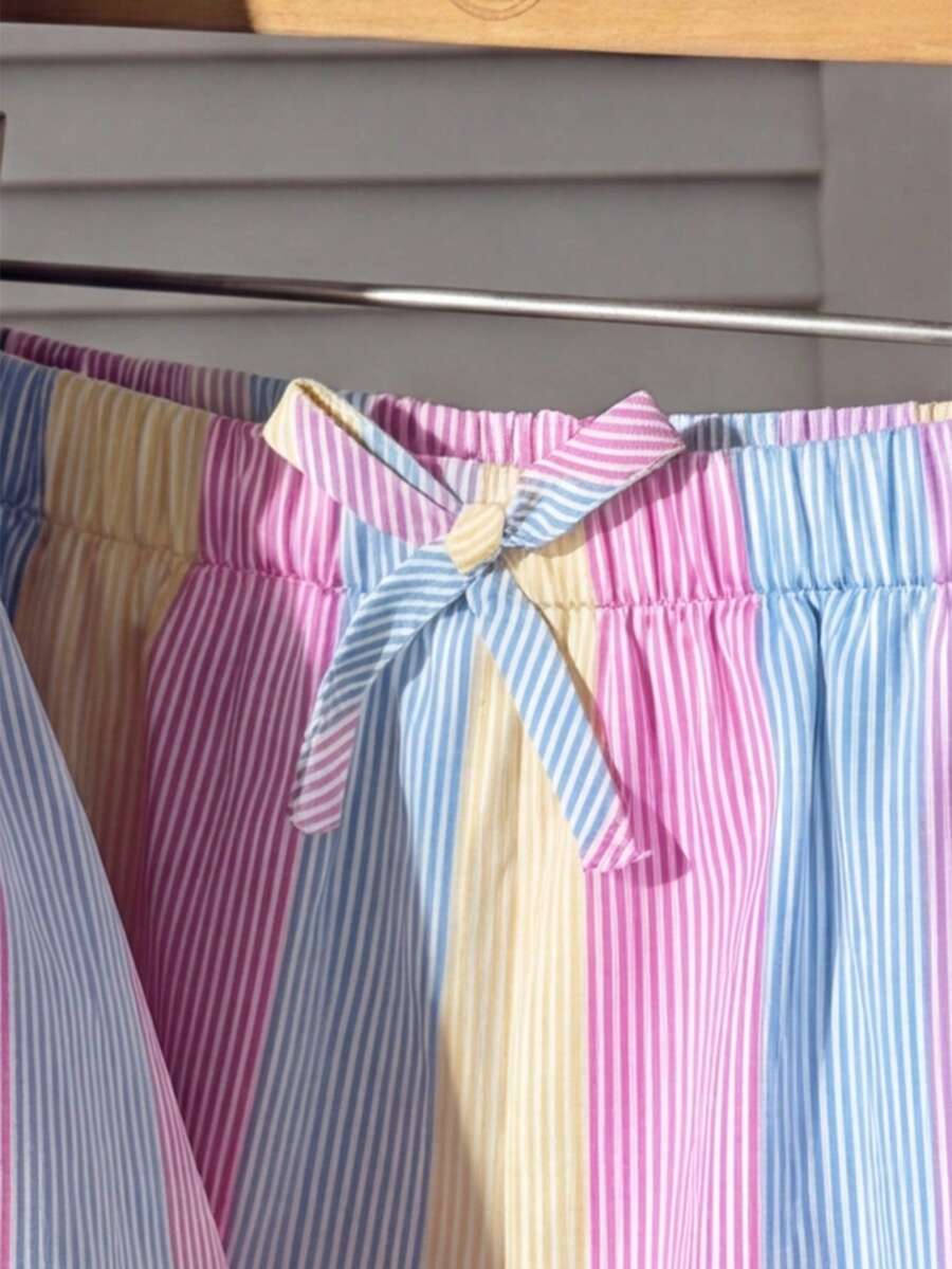 Tween girls 2-piece summer vacation set featuring a multicolored geometric print sleeveless camisole top with bow knot detail and matching elastic waist shorts.