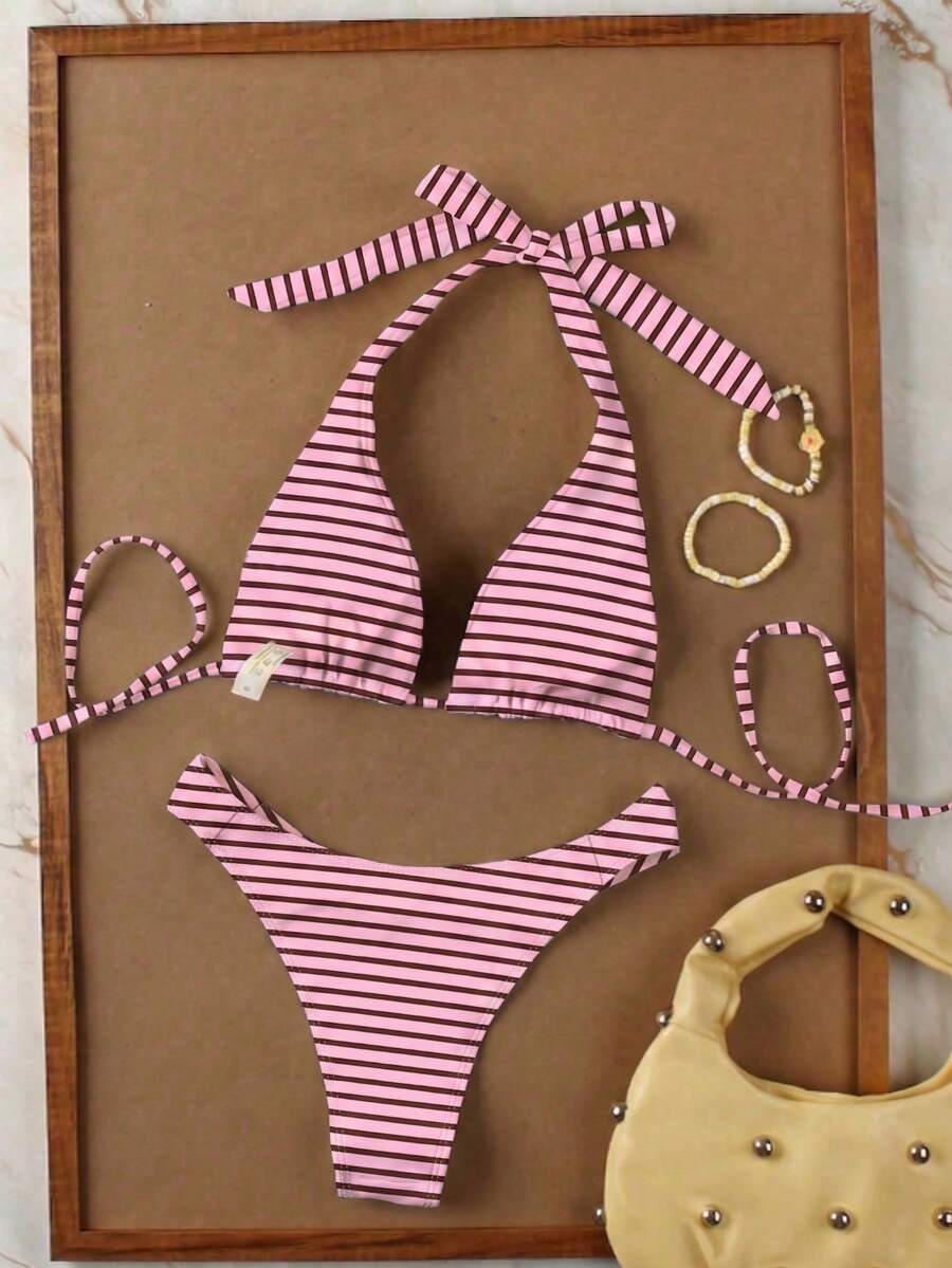 Women's halter neck bikini swimwear set featuring a wireless bra top with removable padding and mid waist bikini bottom.