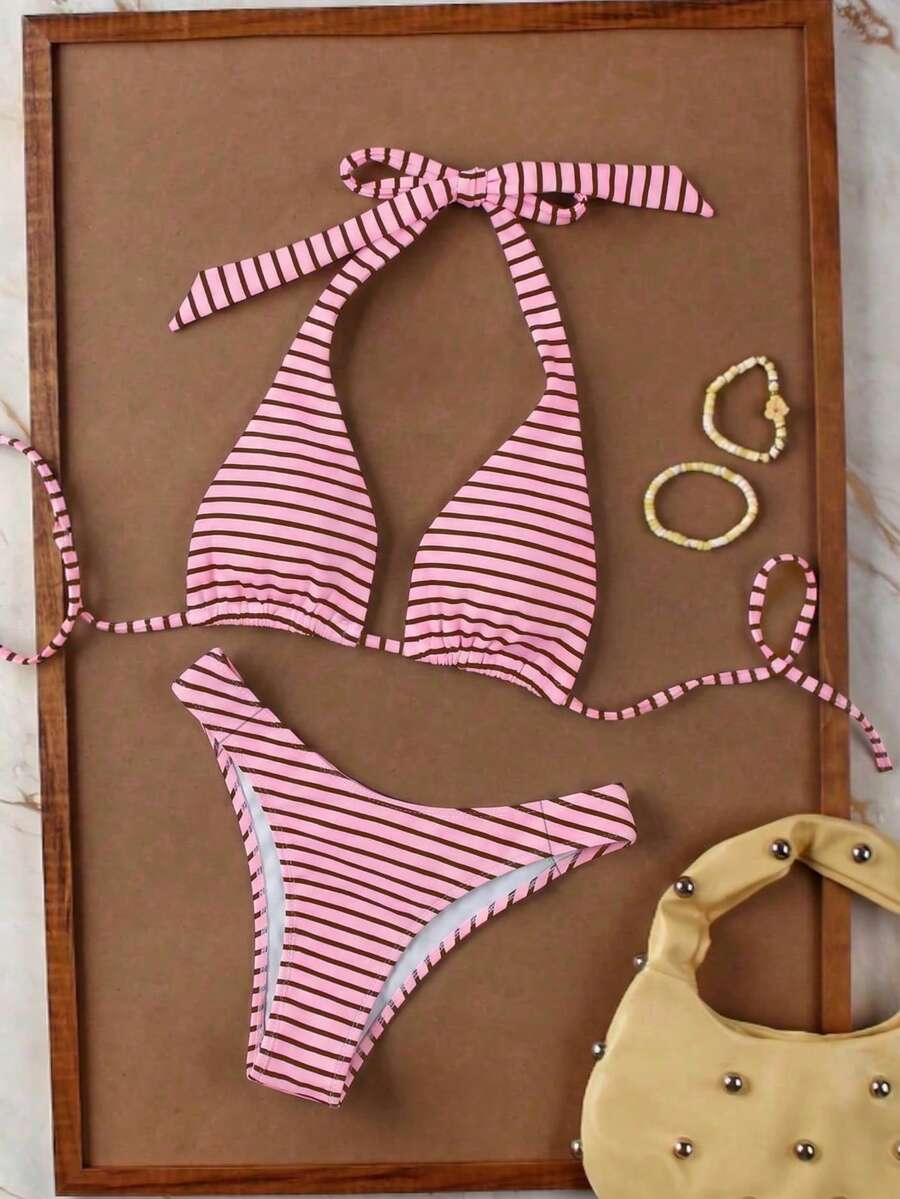 Women's halter neck bikini swimwear set featuring a wireless bra top with removable padding and mid waist bikini bottom.