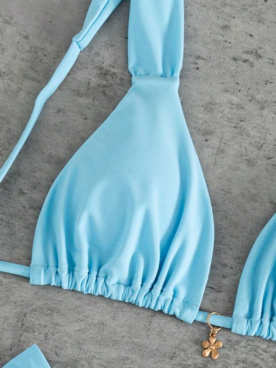 Women's solid yellow 2-piece bikini set featuring a high-waist bottom and a wireless bandeau top on display for beach and resort wear.