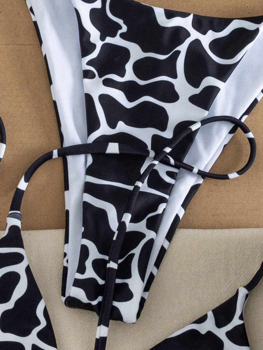 Women's two-piece black bikini set showing a halter triangle tie-back top and matching side-tie bikini bottoms.