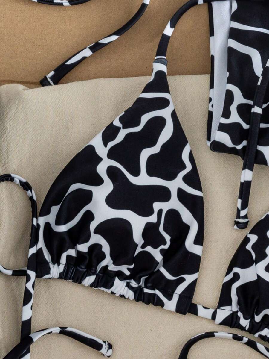 Women's two-piece black bikini set showing a halter triangle tie-back top and matching side-tie bikini bottoms.