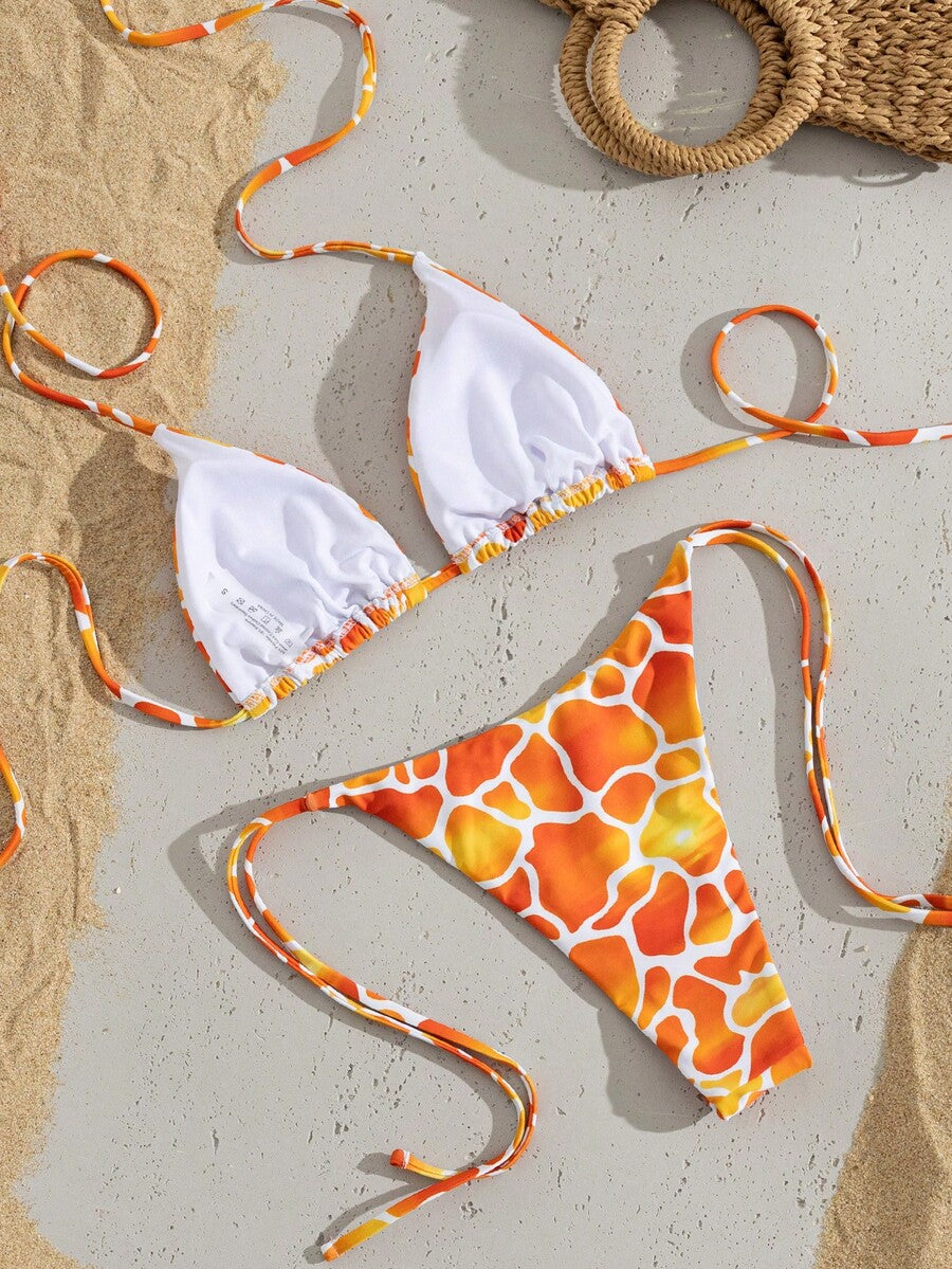 Women's two-piece black bikini set showing a halter triangle tie-back top and matching side-tie bikini bottoms.