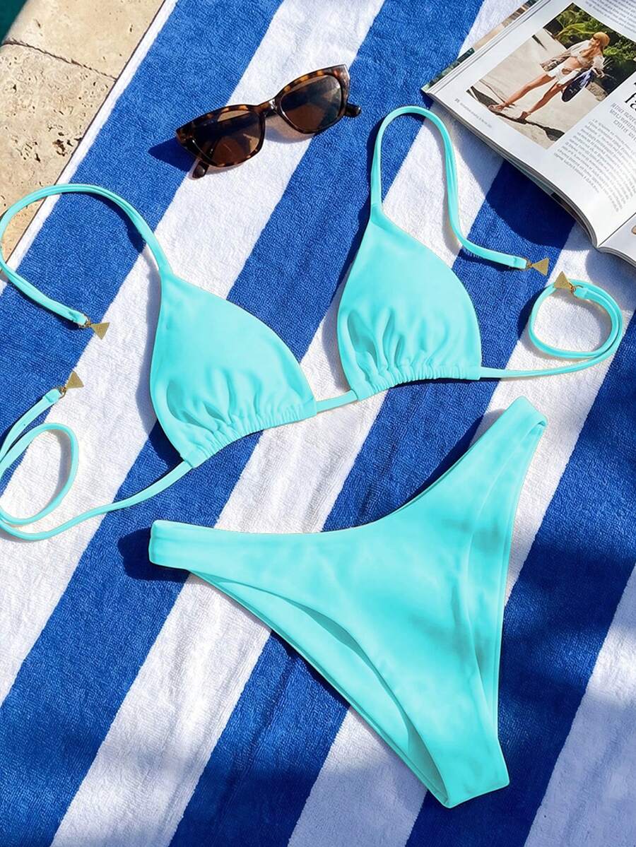 Women's two-piece halter bikini set featuring high cut thong bottoms and removable padding
