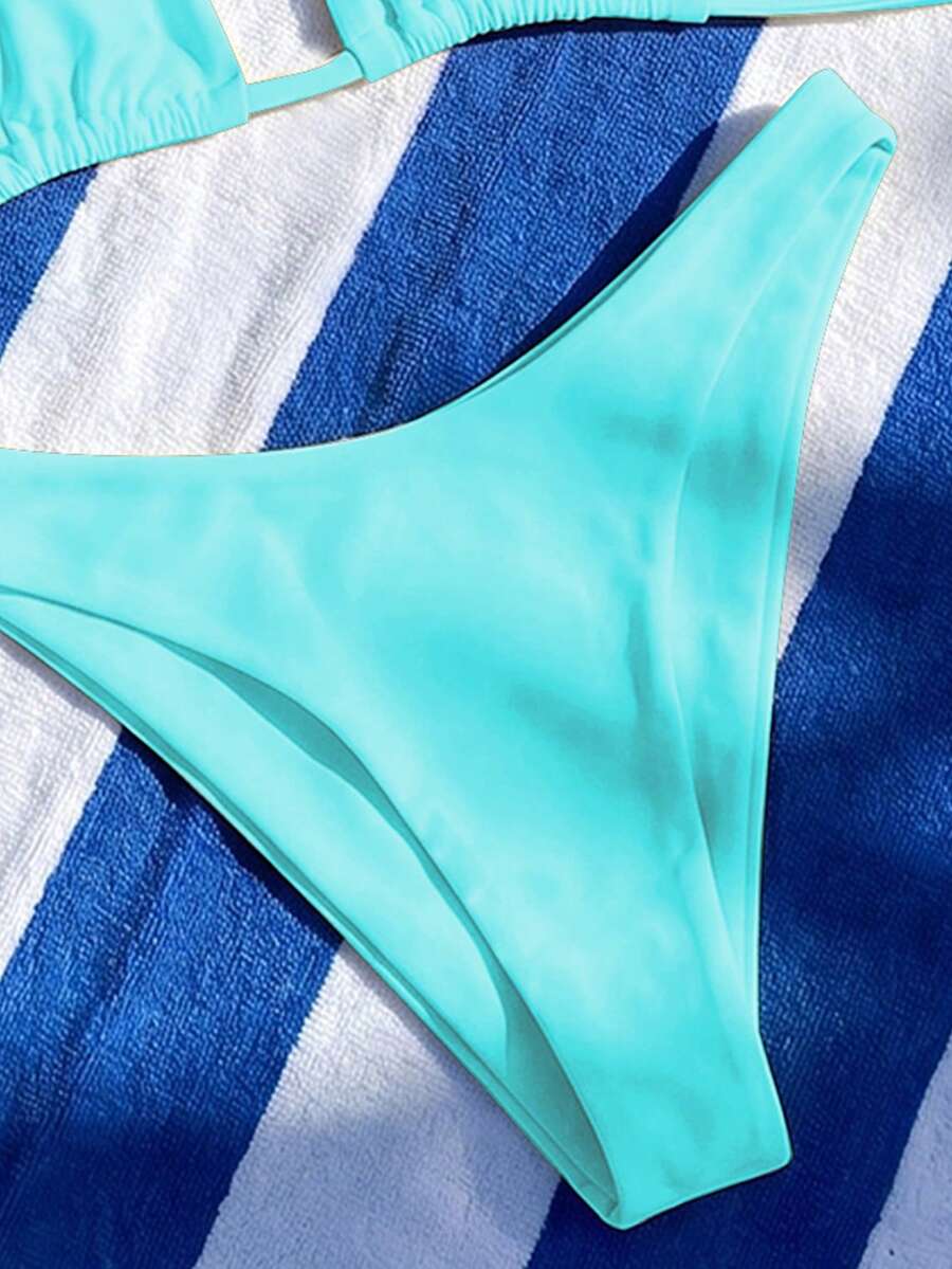 Women's two-piece halter bikini set featuring high cut thong bottoms and removable padding