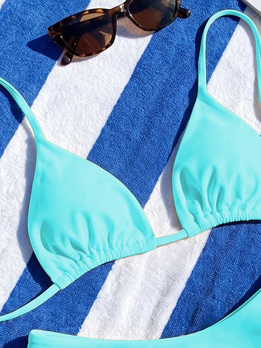 Women's two-piece halter bikini set featuring high cut thong bottoms and removable padding