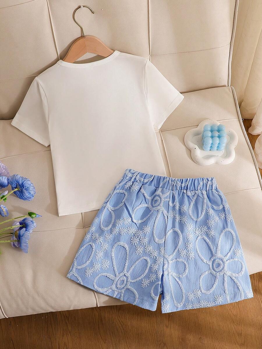 Tween girls 2-piece blue outfit featuring a short sleeve round neck t-shirt with a bow front detail and an asymmetric wrap skort.