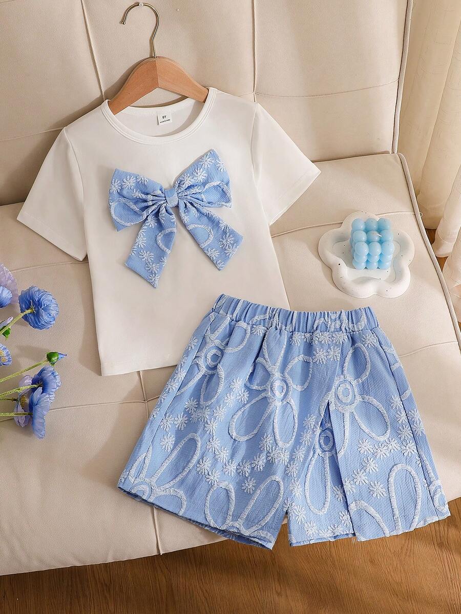 Tween girls 2-piece blue outfit featuring a short sleeve round neck t-shirt with a bow front detail and an asymmetric wrap skort.