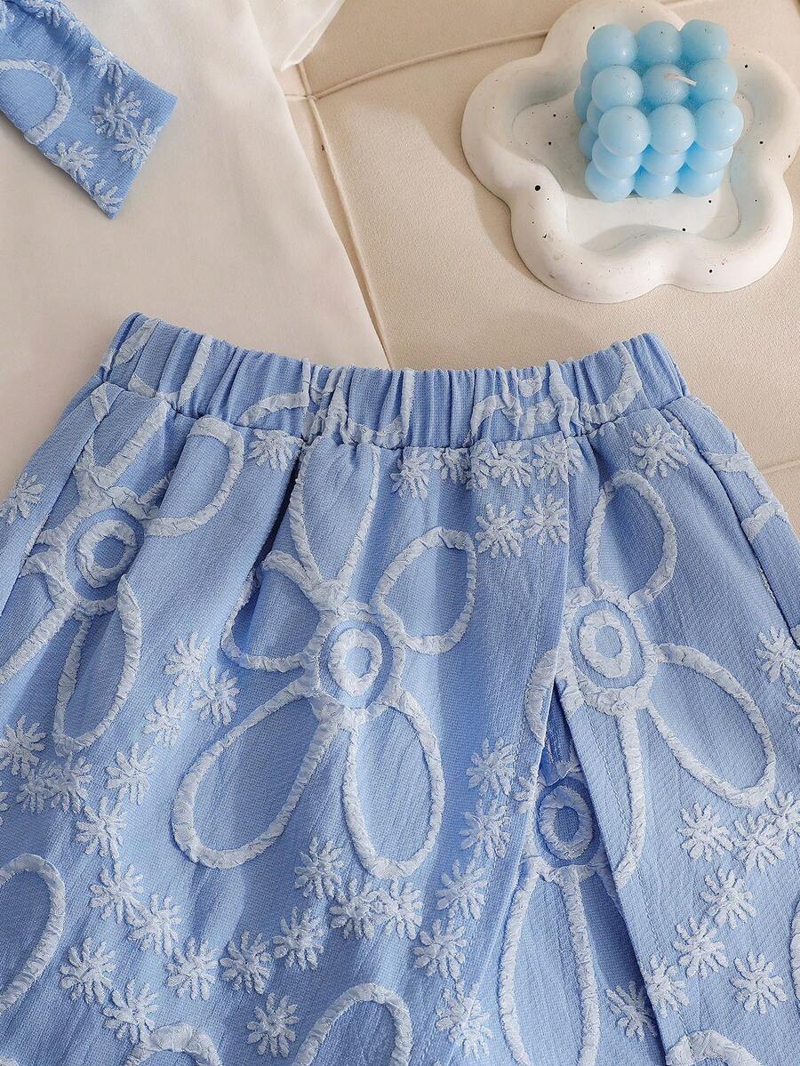 Tween girls 2-piece blue outfit featuring a short sleeve round neck t-shirt with a bow front detail and an asymmetric wrap skort.