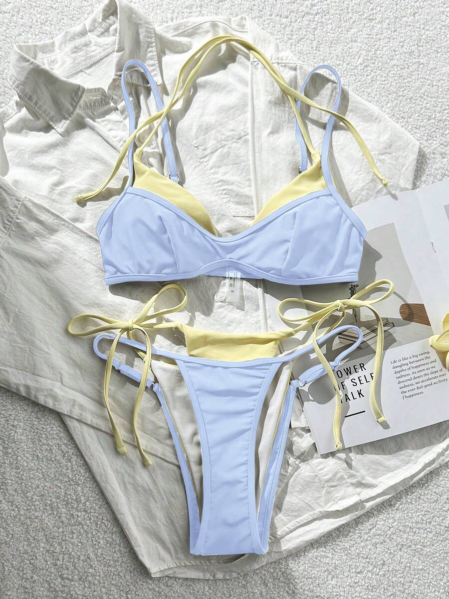 Women's retro polka dot high waist bikini swimsuit set with spaghetti straps and knot tie-back top.