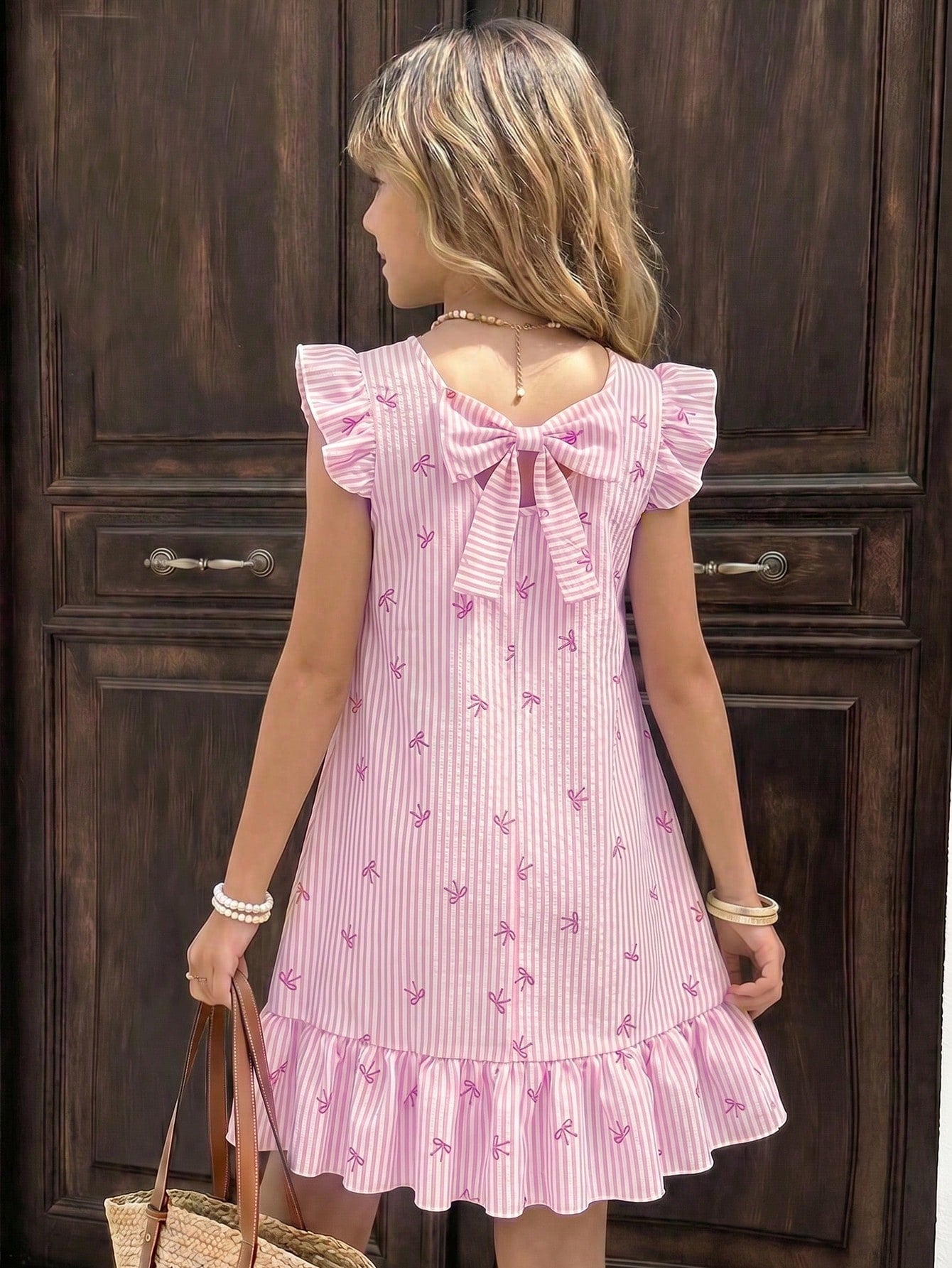 Tween girls apricot vacation midi dress featuring a round neck, cut out details, ruffle flounce accents, and geometric pattern.