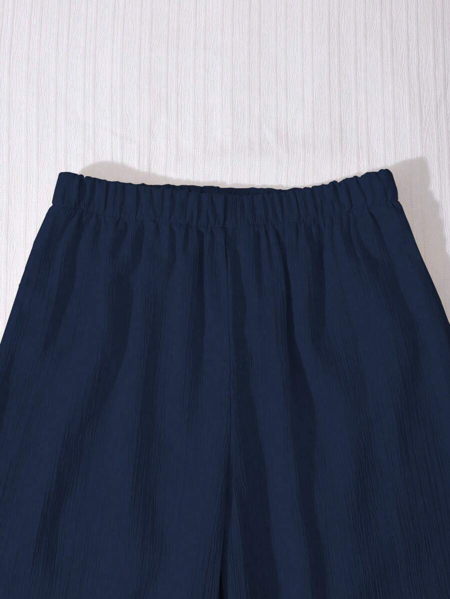 Tween girls casual 2-piece set featuring an apricot woven camisole crop top with back shirring and matching high-waisted loose long pants.