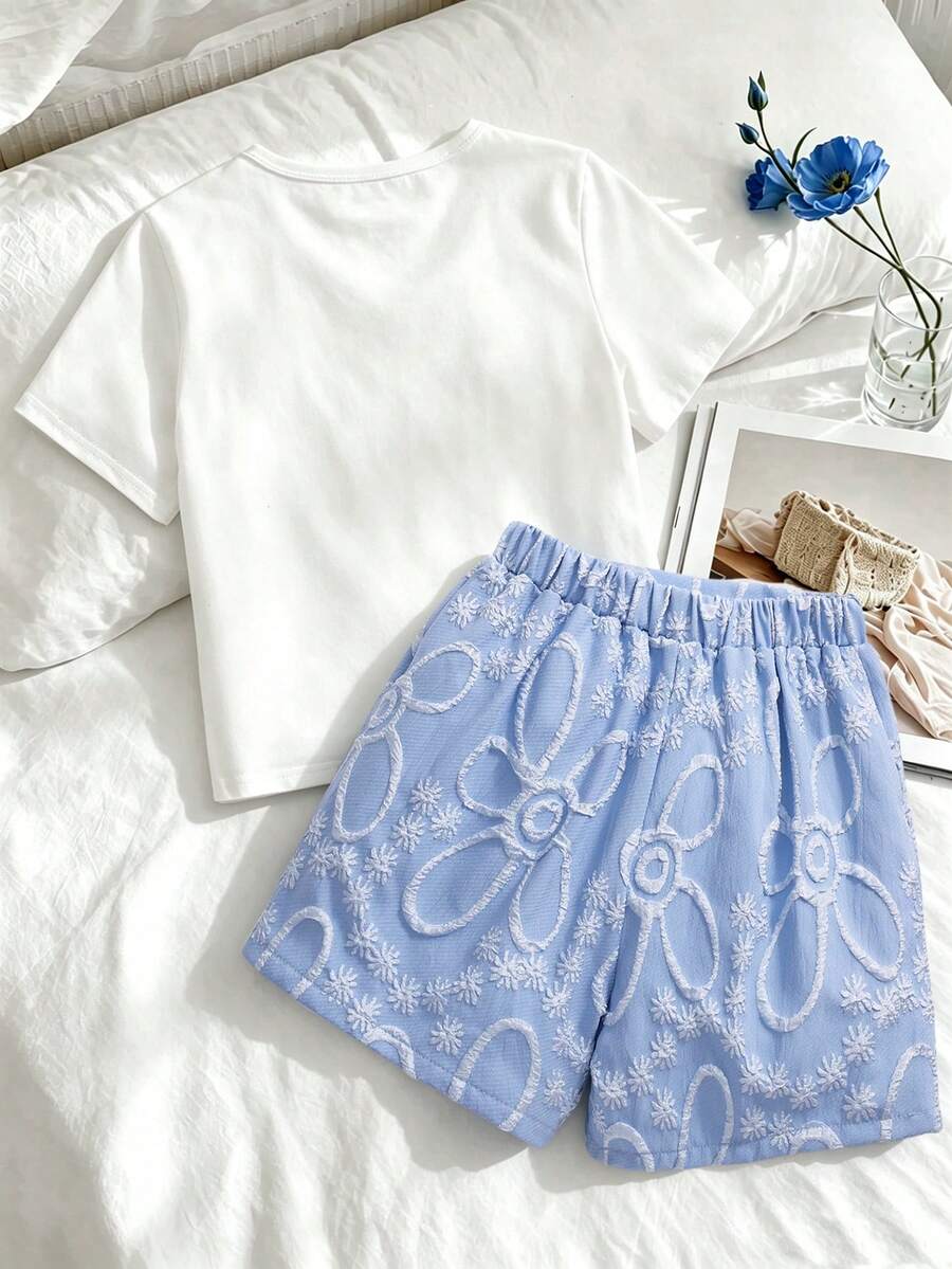 Tween girls 2-piece blue outfit featuring a short sleeve round neck t-shirt with a bow front detail and an asymmetric wrap skort.