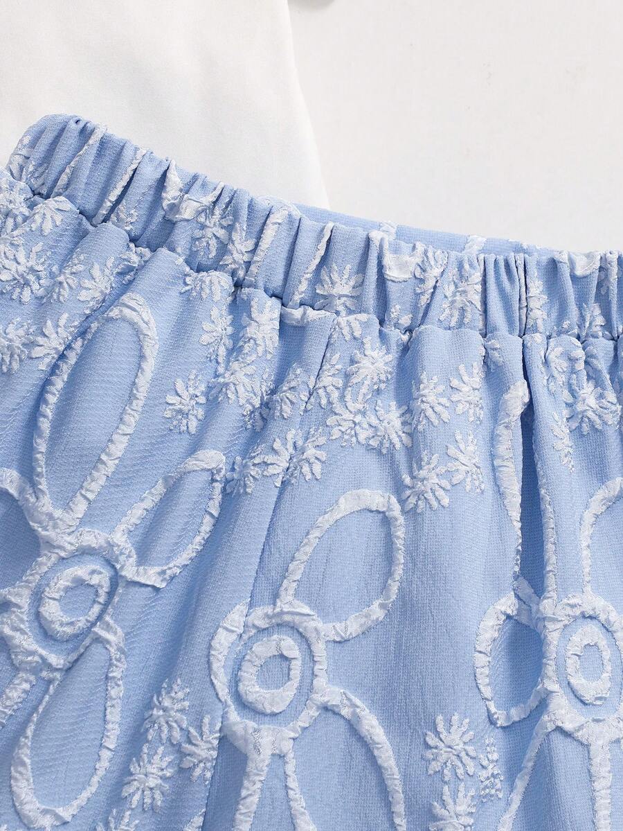 Tween girls 2-piece blue outfit featuring a short sleeve round neck t-shirt with a bow front detail and an asymmetric wrap skort.