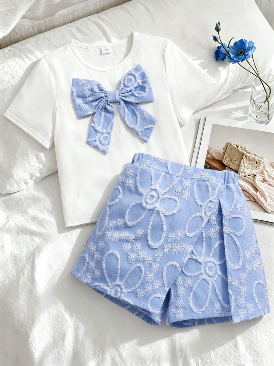 Tween girls 2-piece blue outfit featuring a short sleeve round neck t-shirt with a bow front detail and an asymmetric wrap skort.